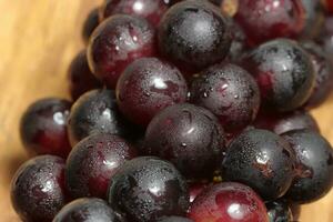 Red grapes on wooden background photo