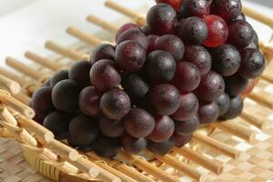 Clusters of ripe grapes on texture background photo