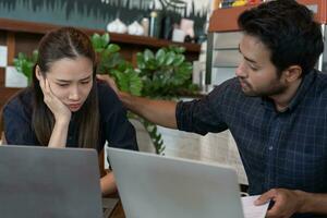 Stress and headache asian couple with large bills no money to pay to expenses and business problem. Husband encourage wife for problem on cafe, Financial problem, mortgage, loan, bankruptcy, poor photo