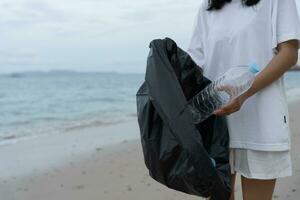 Save water. Volunteer pick up trash garbage at the beach and plastic bottles are difficult decompose prevent harm aquatic life. Earth, Environment, Greening planet, reduce global warming, Save world photo