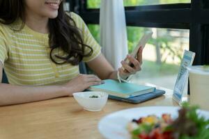 Woman use smartphone to scan QR code to pay in cafe restaurant with a digital payment without cash. Choose menu and order accumulate discount. E wallet, technology, pay online, credit card, bank app. photo