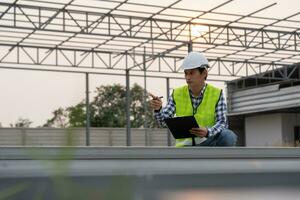 inspector or engineer is inspecting construction and quality assurance new house using a checklist. Engineers or architects or contactor work to build the house before handing it over to the homeowner photo