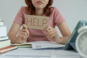 Asian student woman have anxiety because of exams, female prepare for test and learning lessons in the library. stress, despair, haste, misunderstanding reading, discouraged, expectation, knowledge photo