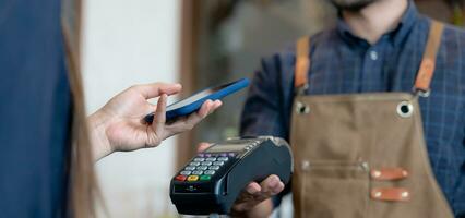 Woman use smartphone to scan QR code to pay in cafe restaurant with a digital payment without cash. Choose menu and order accumulate discount. E wallet, technology, pay online, credit card, bank app. photo