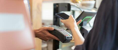 Woman use smartphone to scan QR code to pay in cafe restaurant with a digital payment without cash. Choose menu and order accumulate discount. E wallet, technology, pay online, credit card, bank app. photo