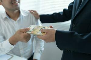 Businessmen receive salary or bonuses Korea won from management or Boss. Company give rewards to encourage work. Smiling businessman enjoying a reward at the desk in the office. photo