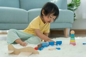 Happy Asia children play and learn toy blocks.family is happy and excited in the house. daughter having fun spending time, Activity, development, IQ, EQ, meditation, brain, muscles, essential skills. photo