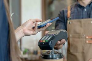 Woman use smartphone to scan QR code to pay in cafe restaurant with a digital payment without cash. Choose menu and order accumulate discount. E wallet, technology, pay online, credit card, bank app. photo