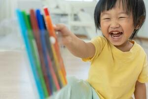 Happy Asia children playing learning paint on paper. Activity, development, IQ, EQ, meditation, brain, muscles, essential skills, family having fun spending time together. Holiday photo