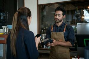 Woman use smartphone to scan QR code to pay in cafe restaurant with a digital payment without cash. Choose menu and order accumulate discount. E wallet, technology, pay online, credit card, bank app photo
