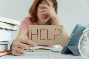 Asian student woman have anxiety because of exams, female prepare for test and learning lessons in the library. stress, despair, haste, misunderstanding reading, discouraged, expectation, knowledge photo