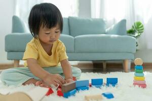 Happy Asian child playing and learning toy blocks. children are very happy and excited at home. child have a great time playing, activities, development, attention deficit hyperactivity disorder photo