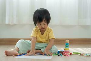 Happy Asia children playing learning paint on paper. Activity, development, IQ, EQ, meditation, brain, muscles, essential skills, family having fun spending time together. Holiday photo