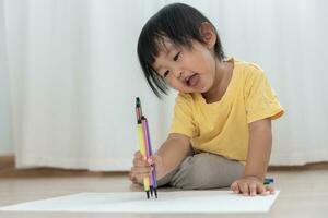 Happy Asia children playing learning paint on paper. Activity, development, IQ, EQ, meditation, brain, muscles, essential skills, family having fun spending time together. Holiday photo