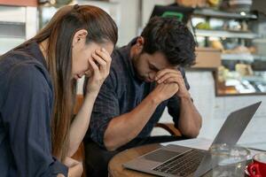 Stressed and headache asian couple with large bills or invoices no money to pay to expenses and business problem. shortage, Financial problems, mortgage, loan, bankruptcy, bankrupt, poor photo