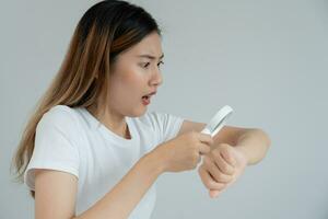 skin problem and beauty. asian woman use magnifying glass look itchy skin from skin allergic, shocked, steroid allergy, sensitive skin, chemical allergy, rash, insect bites, Seborrheic Dermatitis. photo