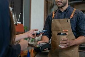 Woman use smartphone to scan QR code to pay in cafe restaurant with a digital payment without cash. Choose menu and order accumulate discount. E wallet, technology, pay online, credit card, bank app. photo