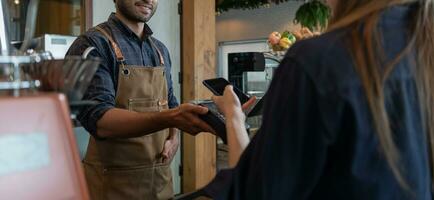 Woman use smartphone to scan QR code to pay in cafe restaurant with a digital payment without cash. Choose menu and order accumulate discount. E wallet, technology, pay online, credit card, bank app. photo
