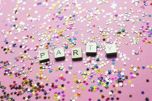party word on a multicolor sparkles pink purple background. photo