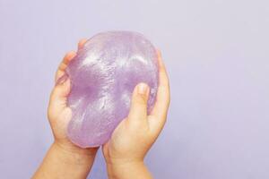 Making slime at home. child stretching colorful slime. DIY concept. photo