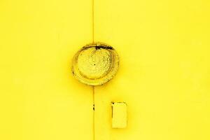 metal yellow doors with a lock abstract background. Monocolor texture pattern with copy space photo