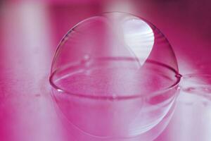 soap bubble close up. abstract pink water background photo