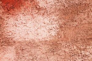 Decorative plaster concrete background. Multicolor red and brown wall close up photo