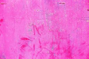 Rusty pink metal abstract background. Texture of an old plate with dripping stained cracked paint photo