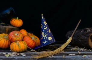 composition with witch hat, broom and halloween pumpkins photo