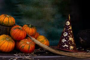 composition with witch hat, broom and halloween pumpkins photo