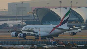 BANGKOK, THAILAND JANUARY 21, 2023 - Airbus A380 of Emirates braking after landing at Suvarnabhumi Airport. Widebody airliner arriving. Cinematic shot of airplane, side view Travel concept video