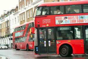 Gorgeous Low Angle view of Bus Service and British Traffic at Central London City of England UK. Image Captured on August 2nd, 2023 During Cloudy and Rainy Day. photo