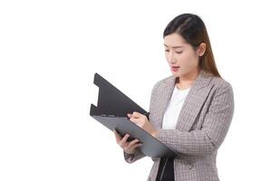 Long-haired Asian business woman hold the clipboard in hand while working at home isolated on white background. photo