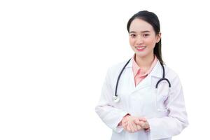 Young professional Asian woman doctor in medical uniform is standing smiling confidently holding hands while working isolated on white background. healthcare concept photo