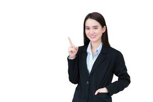 Professional young Asian working woman who has long hair wears black formal suit with blue shirt while she arm crossing and pointing up to present something while isolated on white background. photo