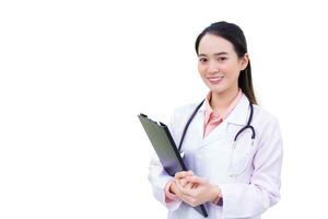 Young professional Asian woman doctor working at hospital. She wear white robe and stethoscope and hold clipboard in her hands while isolated on white background. photo