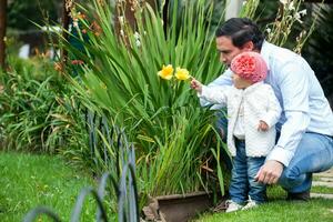 Beautiful baby girl having fun outdoors with her father . Fatherhood concept. Happiness concept. Family concept photo