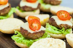 Step by step preparation of mini burgers. Homemade mini burgers for children or appetizers. Small hamburgers. Assembling burgers photo