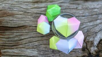 Paper hearts in glass bottles on wooden floor with blurred trees background concept for cheering LGBTQ people around the world photo