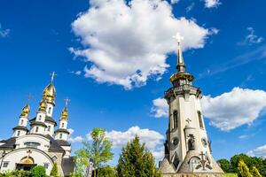 Christian church cross in high steeple tower for prayer photo