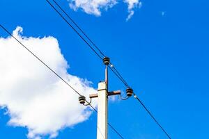 Power electric pole with line wire on colored background close up photo