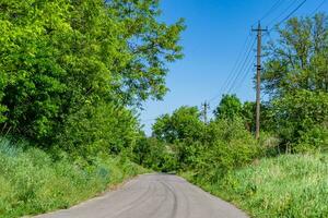 Beautiful empty asphalt road in countryside on colored background photo