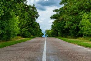 Beautiful empty asphalt road in countryside on colored background photo