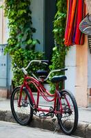 Bicycle parked at the beautiful streets of the walled city in Cartagena de Indias. Urban bicycle concept. Mobility concept photo