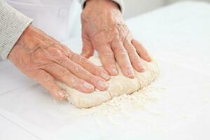 kneading by hand. Home made pizza dough preparation. Pizza preparation. photo