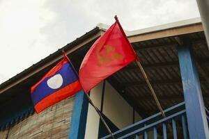 Laos flag and communist party flag decorated on laos people house photo