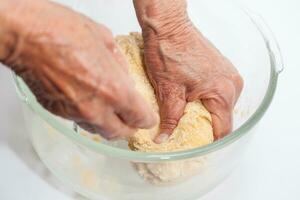 Ravioli Preparation. Kneading pasta dough by hand photo