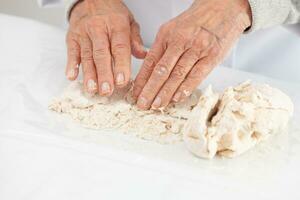 kneading by hand. Home made pizza dough preparation. Pizza preparation. photo