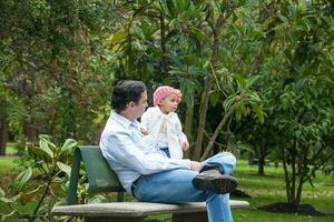 Young father having fun outdoors with his baby girl. Fatherhood concept. Happiness concept. Family concept photo