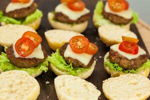Step by step preparation of mini burgers. Homemade mini burgers for children or appetizers. Small hamburgers. Assembling burgers photo